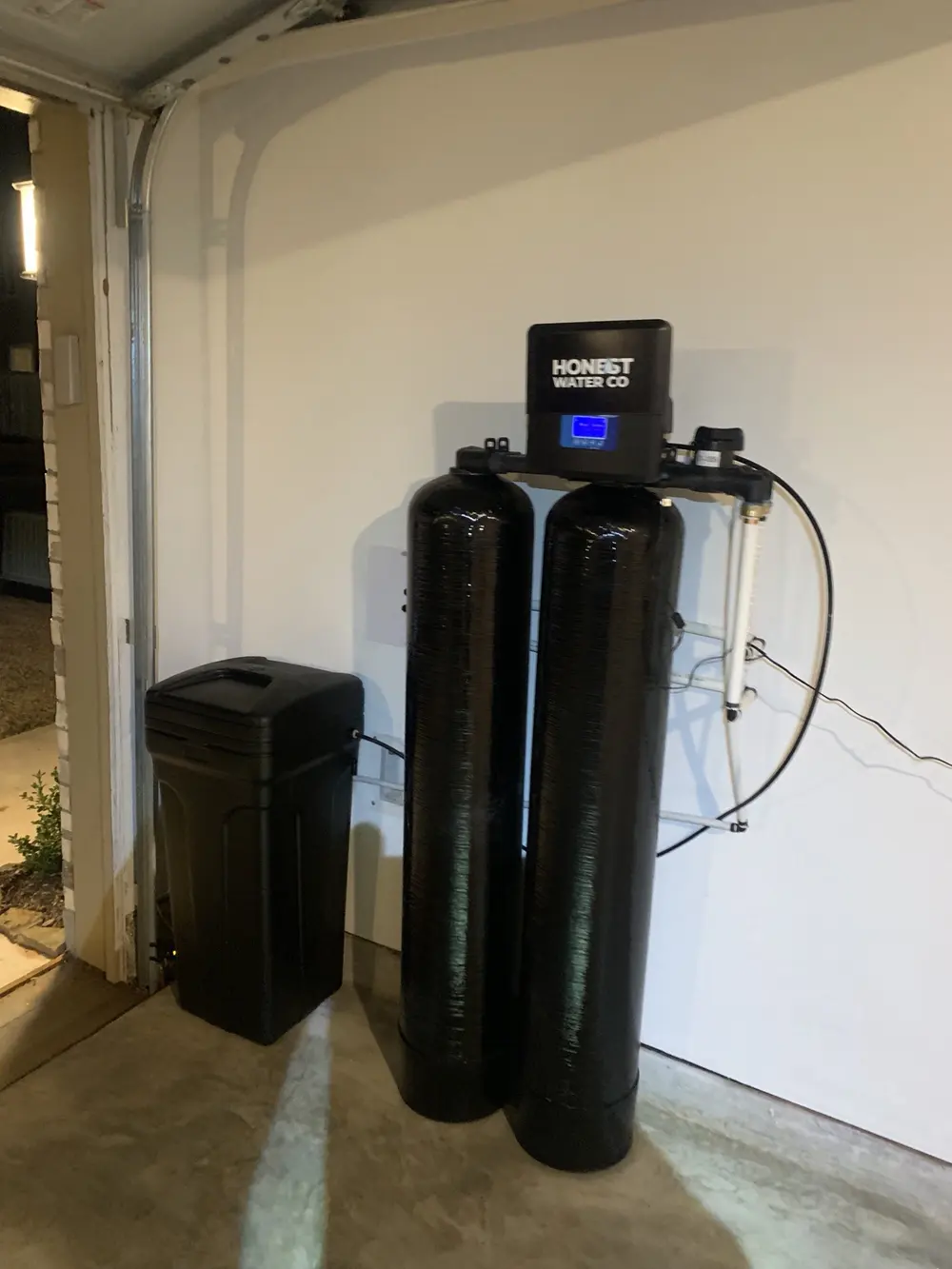 Dual-tank system with lit digital display installed just inside a garage door